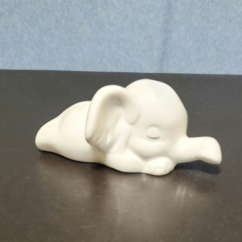 Baby sleeping porcelain elephant. 3 to 4 inches
